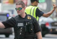 A Secret Service agent directing traffic in an urban setting