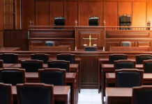 Weinstein Retrial Chaos: Jury Deadlock Again! Empty courtroom with wooden benches and judges bench.