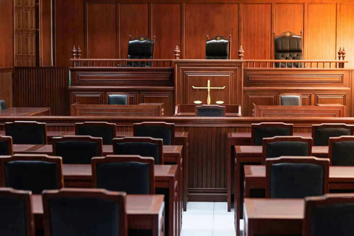 1324425602 Empty courtroom with wooden benches and judges bench.