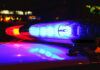 Police car lights flashing at night.