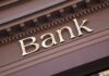 Trump TRANSFORMS Immigrant Bank Rules Close-up of a bank sign with gold lettering
