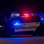 Houston police vehicle with emergency lights activated at night