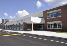 Teacher Scandal Shocks Christian School Modern school building with large windows and a clear sky