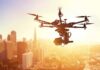 Papa Johns’ Bold Drone Delivery Gamble A drone flying over a city skyline during sunset