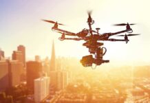 Papa Johns’ Bold Drone Delivery Gamble A drone flying over a city skyline during sunset