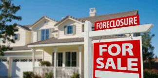 Foreclosure sign in front of a house for sale