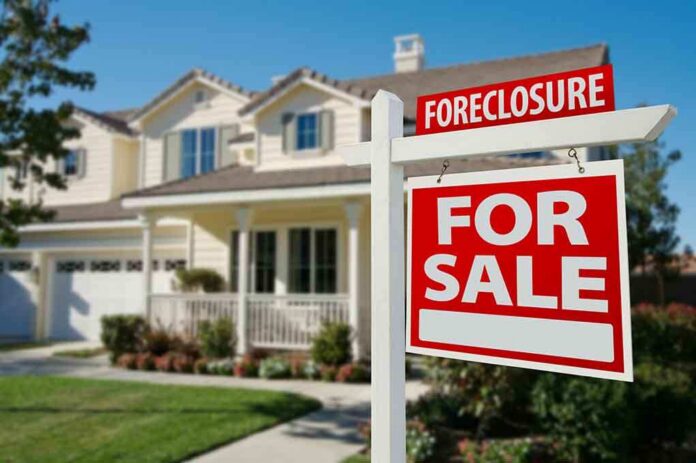shutterstock_50097061 Foreclosure sign in front of a house for sale