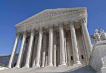 Supreme Court Votes 9-0, Bipartisan SHOCKER! The Supreme Court building featuring grand columns and statues under a clear blue sky