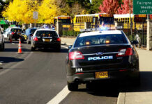 Graduation Chaos – Gunman OPENS FIRE During Ceremony! Police cars and school buses on a road.