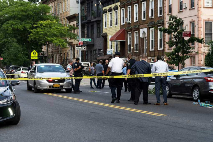 Police gathered at an urban crime scene.