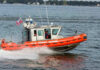 Coast Guard boat speeding on the water.