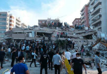 Monster Quake Slams Island – Dozens KILLED! People at a collapsed building after an earthquake.