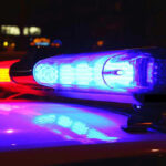 Police car lights flashing at night.
