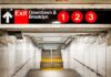 Train Station Bloodbath – Suspect ARRESTED! Subway exit sign indicating Downtown and Brooklyn with train numbers 1, 2, and 3