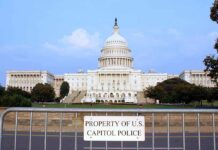 Congress Slaps Trump’s War Moves View of the U.S. Capitol building with a security barrier in front