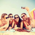 Beach Chaos Erupts – Teens Out Of CONTROL! Group of friends taking a selfie on the beach