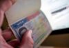 World Cup Fans DENIED Visas – They Got THIS Instead! A hand holding an open passport displaying a visa page