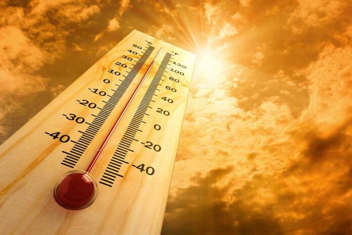 A thermometer displaying temperature against a sunset sky