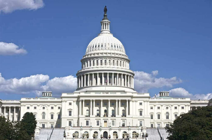 119536138-1 U.S. Capitol building against blue sky.