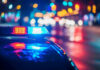 Police car with flashing lights at night.