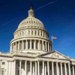 United States Capitol dome against clear blue sky