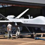 Iran Strikes Rattle U.S. Bases Military drone being serviced by ground crew outside a hangar