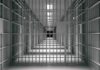 Migrants Account for Half of Prison Inmates! empty prison corridor with barred cells