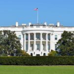 Officials ORDERED To Turnover Phones in White House The White House with the American flag flying in front