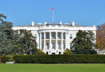 Officials ORDERED To Turnover Phones in White House The White House with the American flag flying in front