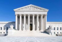 Elected Official TORCHED After Fake Endorsement Scheme! The Supreme Court building featuring marble columns and a clear blue sky