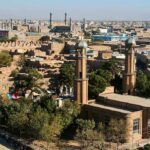 Aerial view of a city featuring traditional buildings and minarets