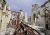 Interior view of a destroyed building with collapsed arches and debris