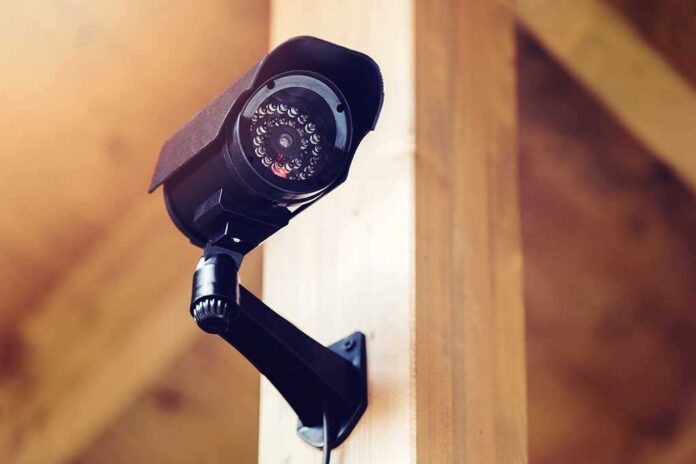 Black,Security,Surveillance,Camera A security camera mounted on a wooden wall