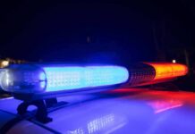 Five Officials Including Mayor ARRESTED For Fraud Police car light bar flashing blue and red at night