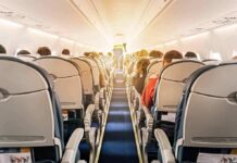 Preacher BOOTED From Flight After She Did THIS! airplane cabin with passengers seated in economy class