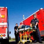 Medic’s Embarrassing BLUNDER Kills Patient Paramedics move a patient on a stretcher between red ambulances