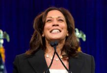 smiling woman speaking at a podium