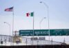 Border crossing with U.S. and Mexico flags and a sign welcoming to Mexico