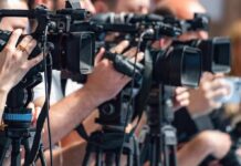 television cameras on tripods at a media event