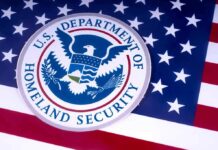 DHS Fires Warning Shot to Migrant Caravan Marching Toward US Border U.S. Department of Homeland Security seal on American flag