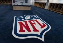 NFL Fans Furious After Leagues Latest Change NFL logo on the floor of an empty locker room