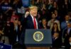 Donald Trump speaking at a rally behind a presidential podium