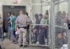 Senate Candidate Would Trade Five Americans for One Illegal Detention facility with people behind chain-link fence and officer nearby