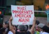Troubling Anti-Ice Message Written at ICE Shooting Site Teddy Williams at a protest holding a sign reading 'Make Immigrants American Again'