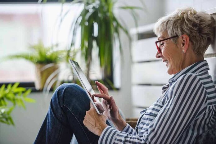 Older woman using a tablet at home