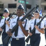 cadets marching in formation with rifles