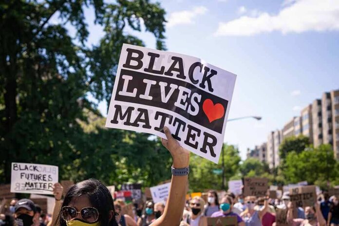 shutterstock_1752911258 protester holding a Black Lives Matter sign at a daytime march