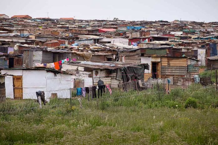 Informal settlement of corrugated metal shacks with laundry hanging