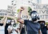 UNHINGED BLM Professor Doxxes ICE Agent Protester in gas mask raises fist during street demonstration