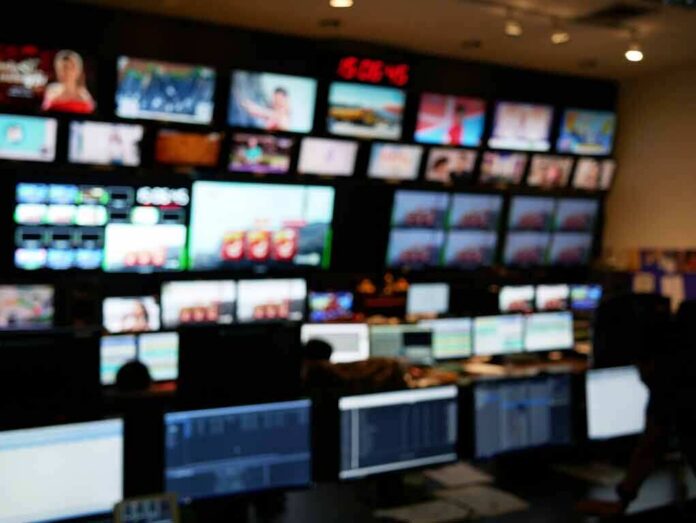 shutterstock_1860150187-1 control room with multiple screens and monitors